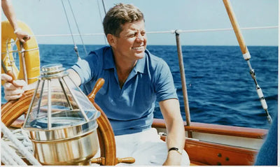 jfk-wearing-a-blue-polo-shirt-and-white-chinos-on-a-boat